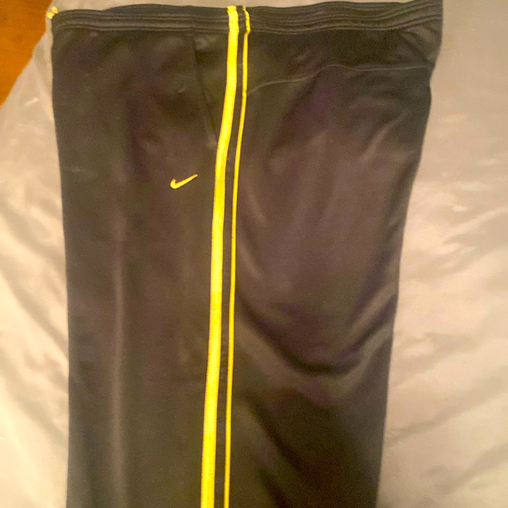 Nike athletic pants/jumpsuit pants size Large Black/gold stripes down each leg.